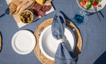 Capri Breeze dark denim blue cotton tablecloth featuring a solid colour and decorative spoke-stitched edging.