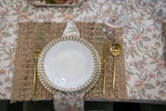 Set of four Country Charm floral table napkins featuring blush pink flowers, sage green leaves and a warm ivory background.