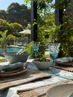 Set of two pale blue ceramic serving bowls in different sizes with decorative raised beaded rims and a smooth glazed finish.