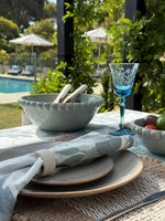 Set of four Moss Meadow cotton table napkins featuring a seafoam green botanical foliage pattern on an off-white background.