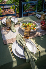 Set of four Golden Hour gold napkin rings featuring a decorative textured gold finish.