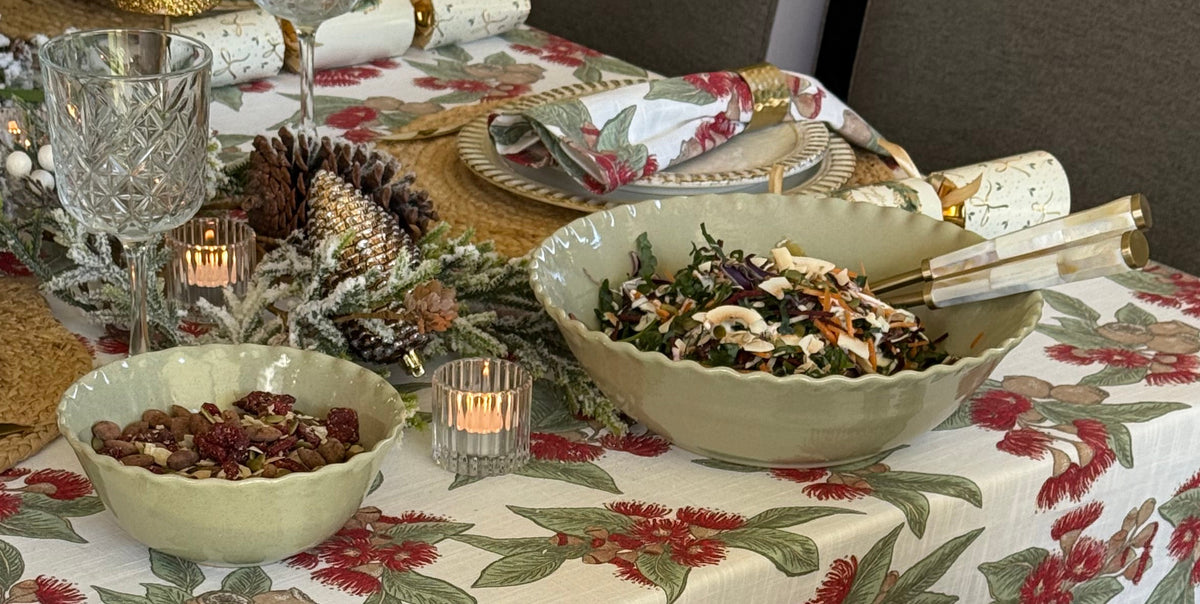 Set of two Marlow sage green ceramic bowls in different sizes with wavy rims and a softly speckled glaze.