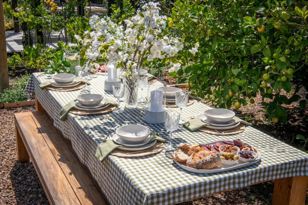 Bayleaf Bounty green gingham cotton tablecloth featuring a classic checked pattern for a rectangular dining table.