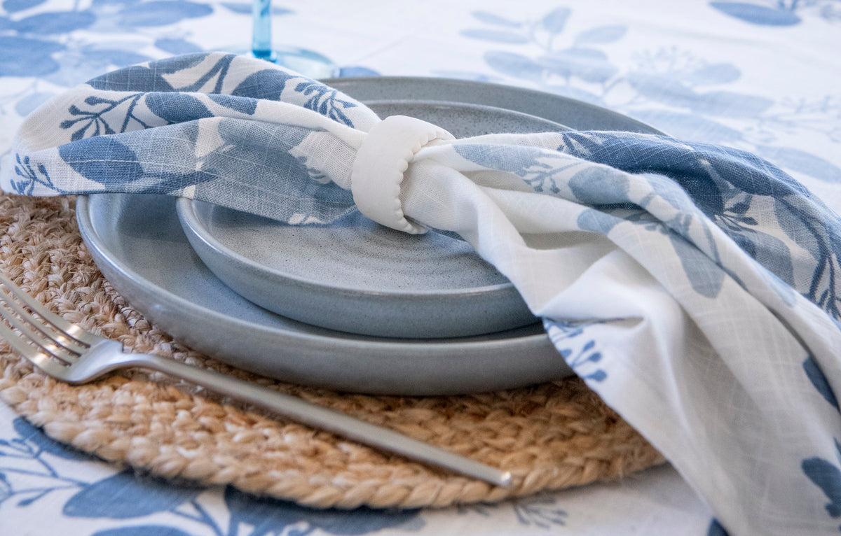 Blue Meadow eucalyptus cotton napkins set of four featuring green botanical foliage on an ivory background.