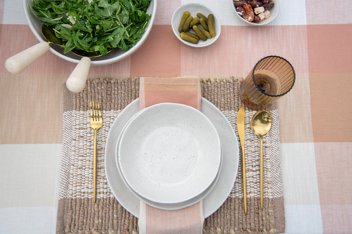 Set of four rust and cream cotton table napkins featuring a classic woven check pattern from the Strawberry Cream Gingham tablescape.