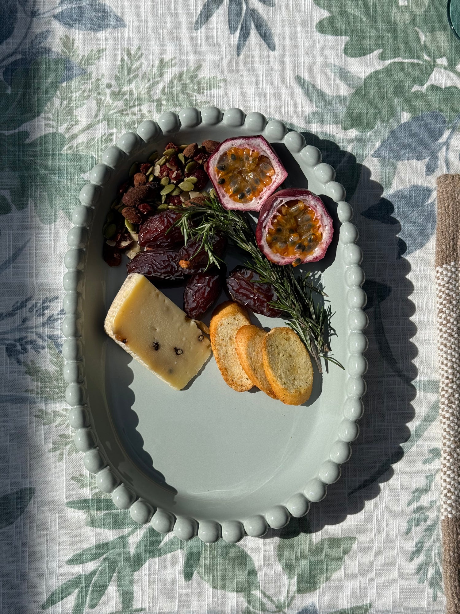 Coastal Blue oval ceramic serving platter featuring a soft pale blue glaze and decorative raised beaded rim.