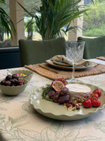 Marlow sage green oval ceramic serving platter featuring a decorative wavy rim and softly speckled glaze.