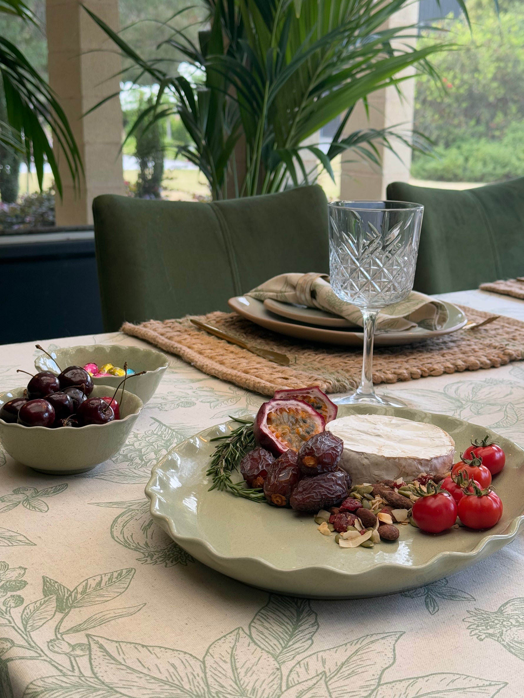 Marlow sage green oval ceramic serving platter featuring a decorative wavy rim and softly speckled glaze.