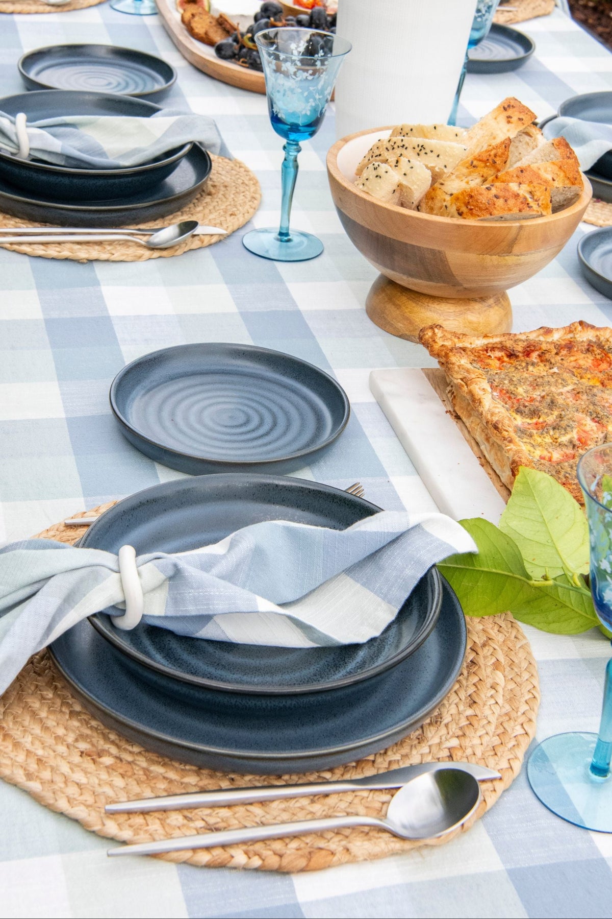 Set of four Blue Sky Gingham cotton table napkins featuring a woven blue and seafoam gingham pattern.