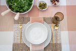Set of four Coastal Haven rectangular jute placemats in white and warm taupe with a chunky woven texture.